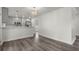 Open concept living room featuring modern gray wood floors connecting to the kitchen at 1892 Buford Dam Rd, Buford, GA 30518