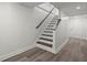 Basement staircase with white walls, and wood treads at 1892 Buford Dam Rd, Buford, GA 30518