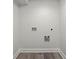 Utility room with hookups and gray wood floors at 1892 Buford Dam Rd, Buford, GA 30518