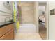 Bright bathroom with a shower, granite countertop, and stylish fixtures connecting to living space at 195 14Th St # 1501, Atlanta, GA 30308