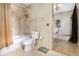 Updated bathroom with tiled walls, modern fixtures, and wood-look flooring leading to closet at 195 14Th St # 1501, Atlanta, GA 30308