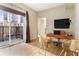 Bright home office includes balcony with amazing city views, desk, and stylish chairs at 195 14Th St # 1501, Atlanta, GA 30308