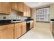 Functional galley kitchen with black appliances, wood cabinets, and a window at 195 14Th St # 1501, Atlanta, GA 30308