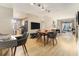 Open-concept living room with wood floors, modern furnishings, and a flat-screen TV, adjacent to the kitchen and dining area at 195 14Th St # 1501, Atlanta, GA 30308