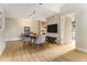 Open-concept living room with wood floors, modern furnishings, and a flat-screen TV, next to a kitchen with stainless appliances at 195 14Th St # 1501, Atlanta, GA 30308