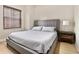 Comfortable bedroom with a gray upholstered bed, neutral walls, and wood-look flooring at 195 14Th St # 1501, Atlanta, GA 30309
