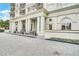 Stately building entrance featuring grand columns, arched windows, and elegant landscaping at 195 14Th St # 1501, Atlanta, GA 30309