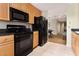 Efficient kitchen featuring black appliances and light wood cabinets at 195 14Th St # 1501, Atlanta, GA 30309