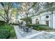 Beautiful outdoor patio with lush greenery, tables, chairs, and manicured hedges at 195 14Th St # 1501, Atlanta, GA 30309