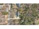 Aerial view of the home nestled among mature trees, showing the roof, driveway, and wooded lot at 195 Willow Way, Stockbridge, GA 30281