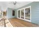 Spacious screened back porch with wood flooring and a ceiling fan at 195 Willow Way, Stockbridge, GA 30281