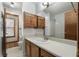 Cozy bathroom features traditional vanity, mirror and ample lighting at 195 Willow Way, Stockbridge, GA 30281