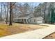Single-story home with an attached garage, long driveway, and covered front porch at 195 Willow Way, Stockbridge, GA 30281