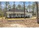 Inviting single-story home with a covered front porch and well-maintained landscaping at 195 Willow Way, Stockbridge, GA 30281