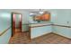 This kitchen features wood cabinets, tile flooring, and an open doorway leading to another room at 195 Willow Way, Stockbridge, GA 30281