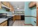 Charming kitchen featuring wood cabinets, laminate countertops, and views to the dining room at 195 Willow Way, Stockbridge, GA 30281
