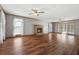 Open living room featuring hardwood floors, a fireplace, and ample natural light at 195 Willow Way, Stockbridge, GA 30281