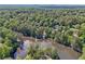 An aerial shot of the community reveals homes nestled among abundant trees surrounding a serene lake at 3734 Fox Hills Se Dr, Marietta, GA 30067