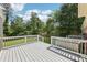 A wooden deck overlooks a green backyard with mature trees at 3734 Fox Hills Se Dr, Marietta, GA 30067