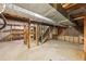 Unfinished basement with exposed ductwork, wood framing, and shelving awaiting customization at 3734 Fox Hills Se Dr, Marietta, GA 30067