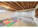 Spacious unfinished basement with concrete floors, exposed ceiling, and a colorful play mat at 3734 Fox Hills Se Dr, Marietta, GA 30067