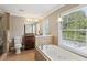 Bathroom with tiled floors, soaking tub, shower and granite countertop vanity at 3734 Fox Hills Se Dr, Marietta, GA 30067