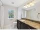 Bright bathroom with granite counters, white tile floors, tub and shower combo at 3734 Fox Hills Se Dr, Marietta, GA 30067