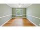Bedroom with hardwood floors, white molding, and a large window with backyard view at 3734 Fox Hills Se Dr, Marietta, GA 30067