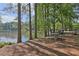 Picnic bench and grill overlooking a scenic lake, creating an inviting spot for outdoor dining at 3734 Fox Hills Se Dr, Marietta, GA 30067
