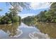 Scenic view of the tranquil community pond reflecting a bright sky and bordered by lush trees at 3734 Fox Hills Se Dr, Marietta, GA 30067