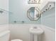 Well-lit powder room with pedestal sink and classic design at 3734 Fox Hills Se Dr, Marietta, GA 30067