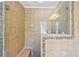Tile shower featuring glass doors and custom tile border at 3734 Fox Hills Se Dr, Marietta, GA 30067