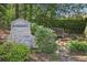 Stone monument displaying the Somerset neighborhood name nestled among lush greenery with a small wooden bridge at 3734 Fox Hills Se Dr, Marietta, GA 30067