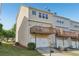 View of the back exterior of this townhome with an attached garage and wooden deck at 1257 Park Pass Way, Suwanee, GA 30024