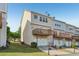 View of the back exterior of this townhome with an attached garage and wooden deck at 1257 Park Pass Way, Suwanee, GA 30024