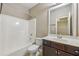 Bathroom with vanity, mirror and shower tub at 1257 Park Pass Way, Suwanee, GA 30024