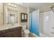 Bathroom with vanity, mirror and shower with blue shower curtain at 1257 Park Pass Way, Suwanee, GA 30024
