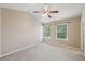 This bedroom features carpet flooring and natural light from the two windows at 1257 Park Pass Way, Suwanee, GA 30024