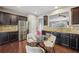 Modern eat-in kitchen featuring stainless steel appliances, granite countertops, and seating for four at 1257 Park Pass Way, Suwanee, GA 30024