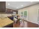 Eat-in kitchen with stainless steel appliances, granite countertops, and wood floors at 1257 Park Pass Way, Suwanee, GA 30024
