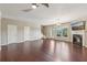 Bright living room featuring hardwood floors, a fireplace, a ceiling fan, and natural light at 1257 Park Pass Way, Suwanee, GA 30024