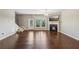 Living room featuring hardwood floors, a fireplace, and a large window with backyard access at 1257 Park Pass Way, Suwanee, GA 30024