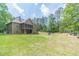 Expansive backyard featuring a screened porch and lush green lawn perfect for outdoor activities and relaxation at 255 Nicklaus Cir, Social Circle, GA 30025