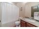 Well-lit bathroom with a shower and tub combination and a single sink vanity at 255 Nicklaus Cir, Social Circle, GA 30025
