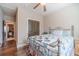Bedroom with wood-look flooring, ceiling fan, large window and walk-in closet at 255 Nicklaus Cir, Social Circle, GA 30025