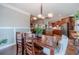 Dining room featuring hardwood floors, natural light, and adjacent to the kitchen at 255 Nicklaus Cir, Social Circle, GA 30025