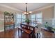 Bright dining room with hardwood floors, natural light, and neutral paint at 255 Nicklaus Cir, Social Circle, GA 30025