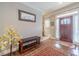 Welcoming foyer featuring hardwood floors, a bench, and a decorative area rug at 255 Nicklaus Cir, Social Circle, GA 30025