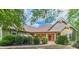 Charming single-Gathering home with a covered porch, brick accents, and well-manicured landscaping at 255 Nicklaus Cir, Social Circle, GA 30025