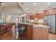 Open-concept kitchen featuring stainless steel appliances, wood cabinets, and eat-in island at 255 Nicklaus Cir, Social Circle, GA 30025